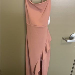 Light pink long dress with slit on side. Straps cross in back. Never worn